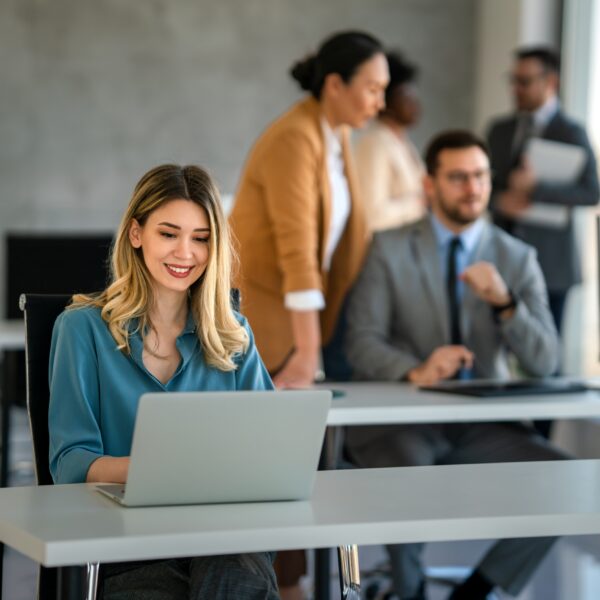 Young,Happy,Successful,Business,Woman,Working,With,Laptop,In,Corporate