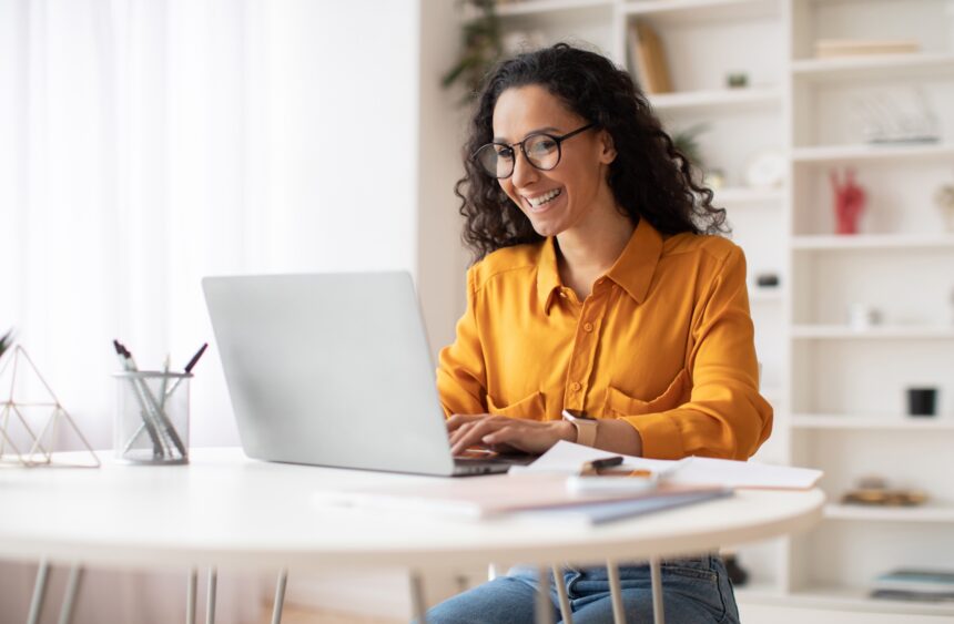 Happy,Middle,Eastern,Businesswoman,Using,Laptop,Typing,And,Working,Online